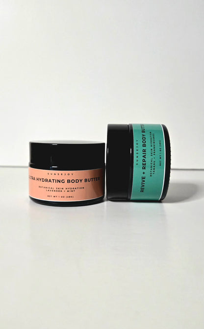 Two jars of body butter on a white background